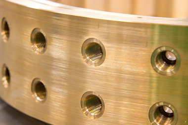 gold-metal-industrial-part-with-holes-2026-03-26-07-19-07-utc